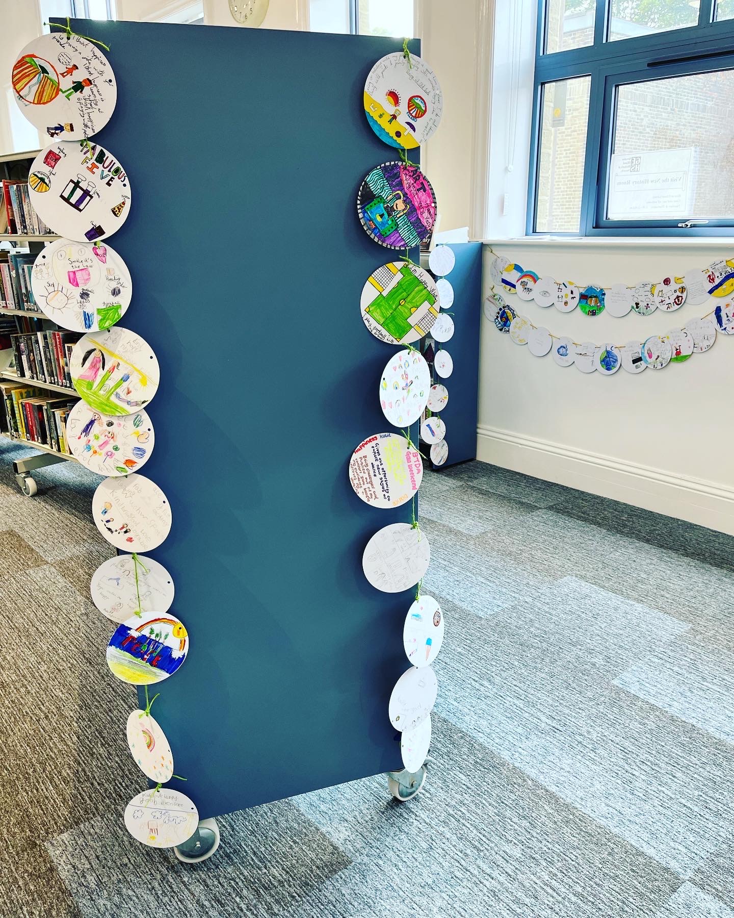 Colourful circular cards hang down the side of a bookcase
